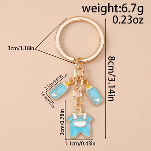 Detailed view of creative baby shower keychain with blue bottle and romper charms