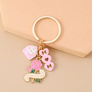 Detail of MOM heart keychain with pink rose and I love MOM envelope charm