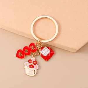 Detailed close-up of Mother's Day gold keychain with MOM heart and enamel rose envelope