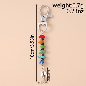 Macro shot of boho keychain with colorful stone beads and natural seashell pendant