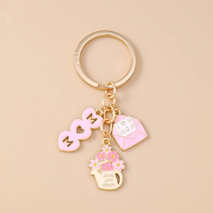 Detailed close-up of Mother's Day gold keychain with pink enamel MOM heart pendants