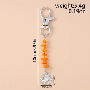 Detail view of a shell pendant keychain with orange beads and dimensions in inches