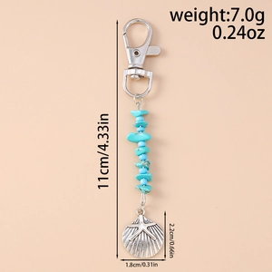 Detailed view of sea shell keychain with blue stones and dimensions marked