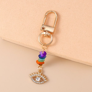 Detail of evil eye keychain with colorful raw stones and sparkling rhinestone eye charm