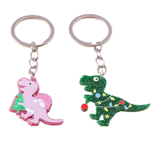 Minimalist dinosaur keychains with Christmas theme for bags and keys on white background
