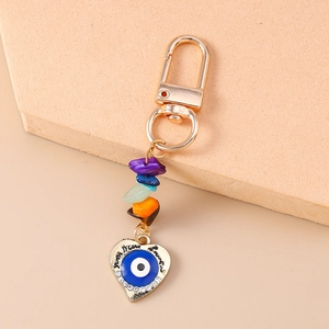 Detailed macro view of heart evil eye keychain with rhinestones and natural gemstones