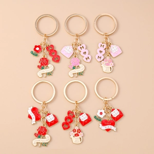 Set of 6 gold Mother's Day keychains with hearts, roses and envelopes on beige background