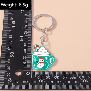 Christmas snowman cup keychain showing weight at 6.5g and dimensions via ruler