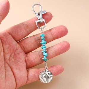 Detailed view of sea shell charm keychain with blue turquoise beads and starfish pattern