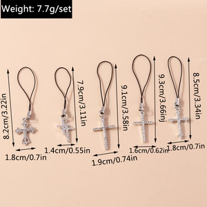 Detailed view of five gothic cross charms with rhinestones and black lanyards for phones