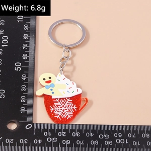 Detailed view of gingerbread man in red coffee cup keychain with measurement ruler
