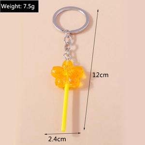 Detail view of yellow floral lollipop keychain showing dimensions 12cm and weight 7.5g