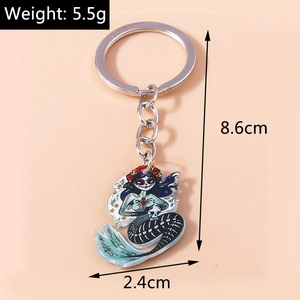 Macro shot of Halloween sugar skull mermaid keychain with vibrant floral acrylic details
