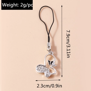 Macro detail of rhinestone butterfly phone charm with silver metal and black cord