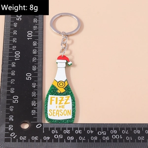 Creative green champagne bottle keychain with glitter and red Christmas hat detail