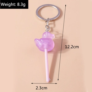 Macro shot of purple duck lollipop keychain with glitter resin and silver metal ring