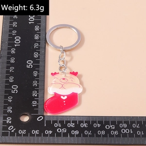 Detailed view of 6.3g Christmas reindeer keychain with sizing scale measurement