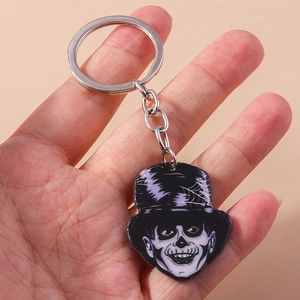 Cartoon Halloween skeleton keychain with purple striped hat on black acrylic pendant