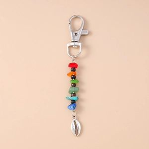 Detailed view of colorful mineral stone beads and silver shell pendant on a keychain