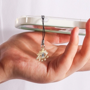 Evil Eye phone charm with blue stones and white diamonds on a gold metallic base