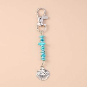 Detailed silver shell charm with star relief and turquoise beads on keychain