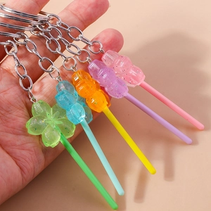 Macro shot of colorful animal lollipop resin keychains with silver chains and glitter