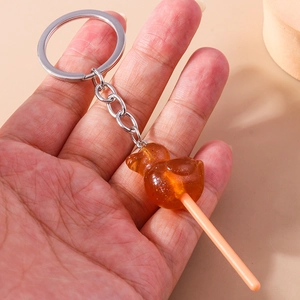 Detail of amber duck lollipop keychain with glitter resin and silver metal ring