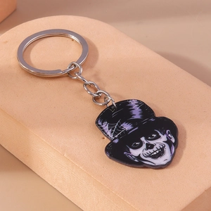 Detailed view of Halloween keychain featuring a gothic clown charm on a beige stand