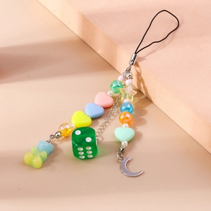 Détail de perles cœur macaron colorées et d'un ours en gomme sur un cordon de téléphone