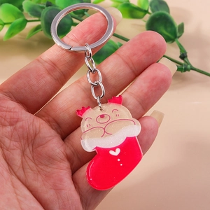 Detail of Christmas stocking acrylic keychain with glitter finish and metallic silver ring