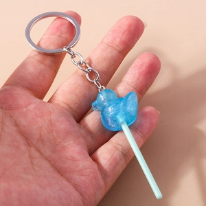 Close-up of a blue translucent duck lollipop keychain with glitter and metal ring