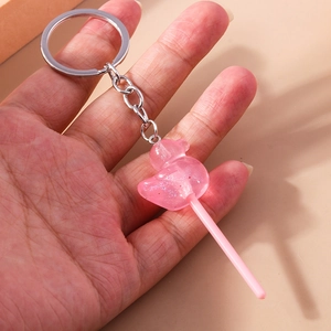 Close-up of pink lollipop keychain with glitter resin and silver metal ring