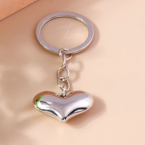 Minimalist silver heart keychain with polished metal pendant and circular ring