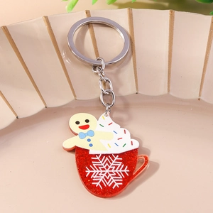 Close-up of a festive Christmas mug keychain with gingerbread man and snowflake details