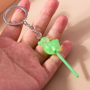 Detail of creative green duck lollipop keychain with glitter and silver metal ring