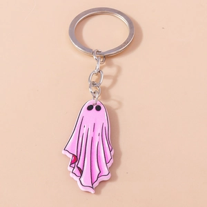 Detailed view of pink cartoon ghost keychain with silver metal ring on neutral background
