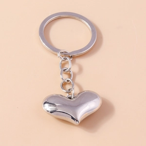 Polished silver heart-shaped metal keychain with a minimalist 3D solid pendant design