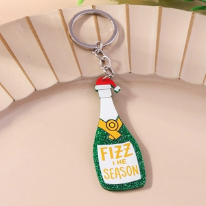 Detail of glitter green champagne bottle keychain with Santa hat and silver ring