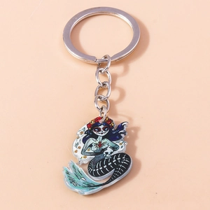 Macro view of Sugar Skull Mermaid keychain with Day of the Dead details and silver ring