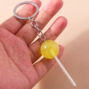 Detail of yellow translucent resin lollipop keychain with glitter and silver metal ring