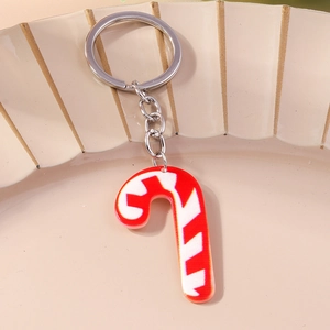 Detail of candy cane keychain with red and white stripes on a decorative plate