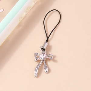 Detail of silver bow phone charm with pink heart crystal and black lanyard attachment