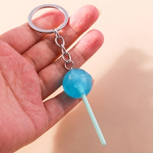 Close-up of blue lollipop keychain with glitter resin ball and silver metal chain