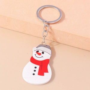 Detail of a Christmas snowman keychain featuring a red scarf on a soft pastel background