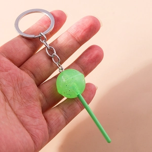Detail of green lollipop keychain with glitter resin ball and silver metal ring