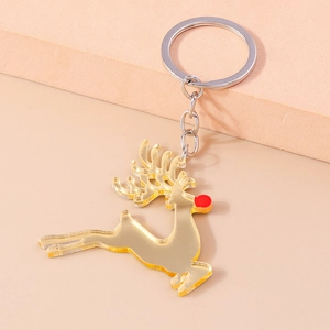 Detail of a gold acrylic reindeer keychain with red nose and polished metallic key ring