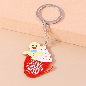 Detail of acrylic gingerbread man in red coffee cup keychain with shimmering glitter finish