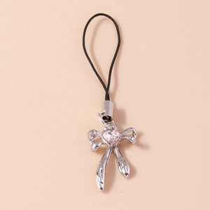 Detail of silver bow pendant with a pink heart-shaped crystal on a black cord