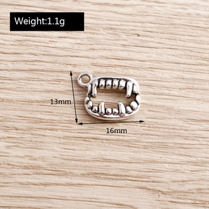 Detailed view of silver alloy vampire tooth charm with precise 13mm by 16mm measurements