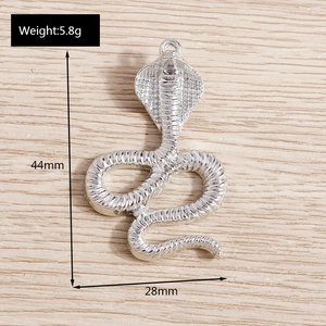 Detail view of cobra snake pendant with dimensions 44mm by 28mm and weight specifications